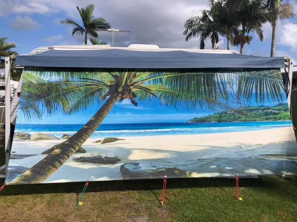 Caravan privacy screen printed with a retro beach shack illustration