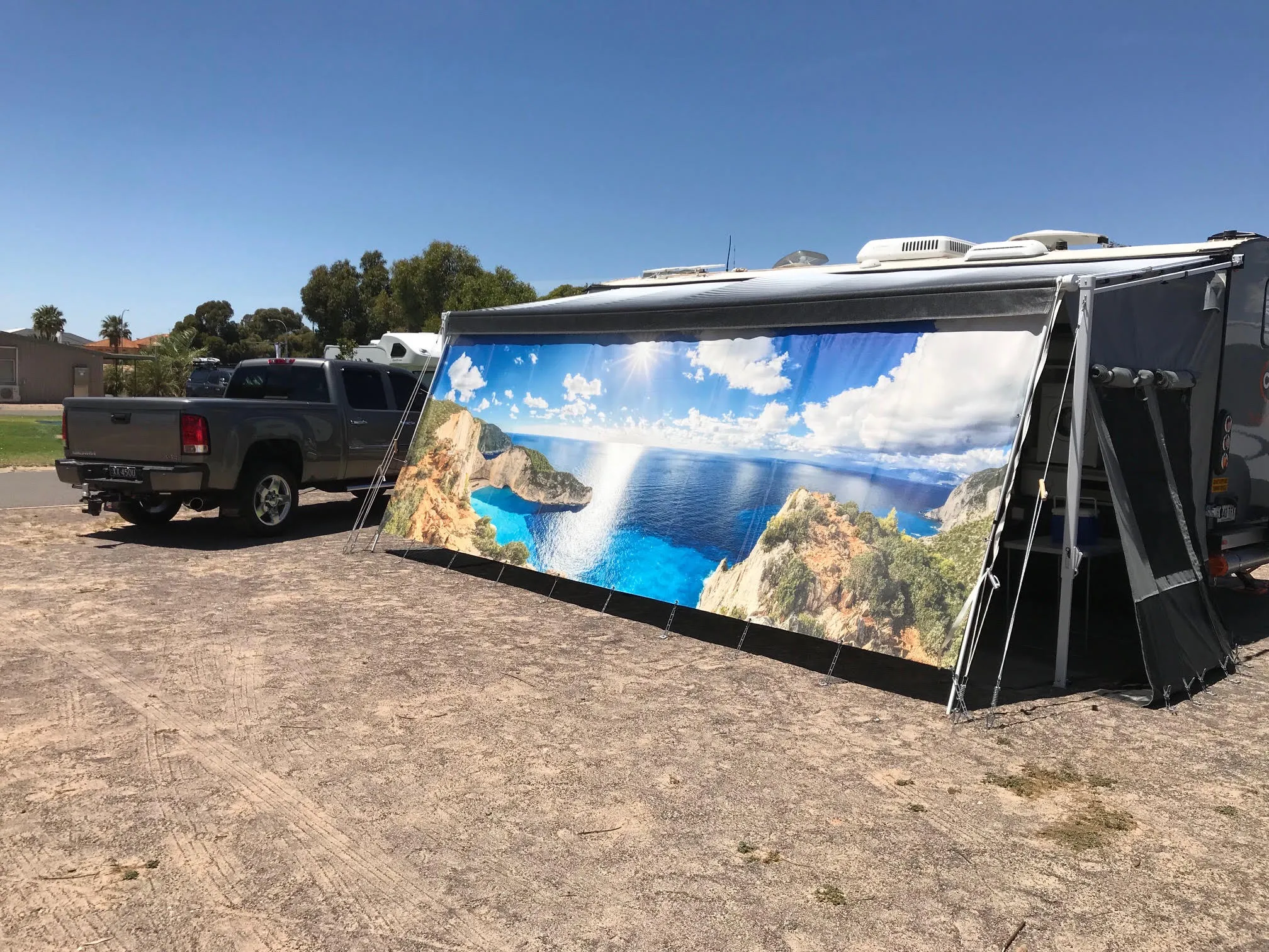 Custom privacy screen on a caravan at the coast